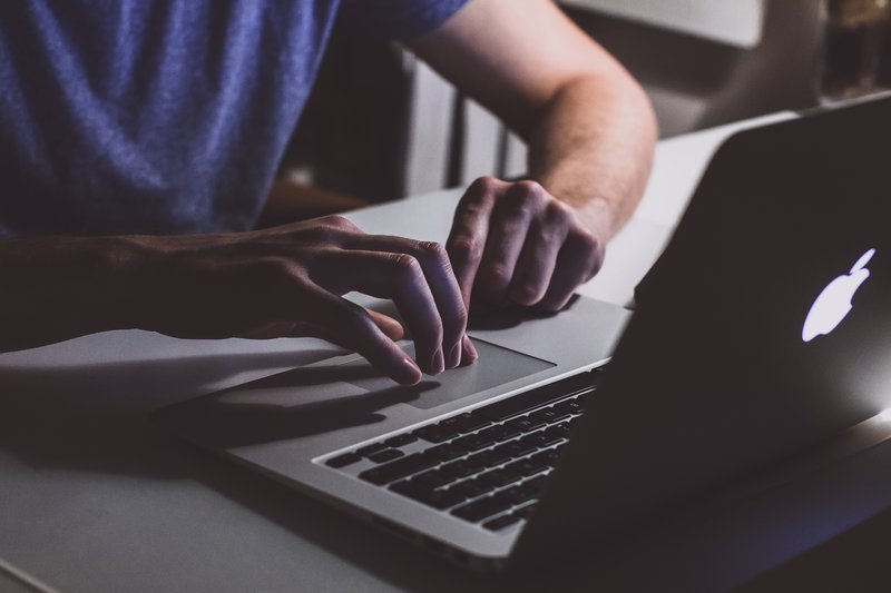 person-touching-open-macbook-on-table-839465.jpg