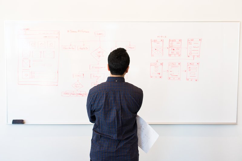 man-standing-infront-of-white-board-1181345.jpg