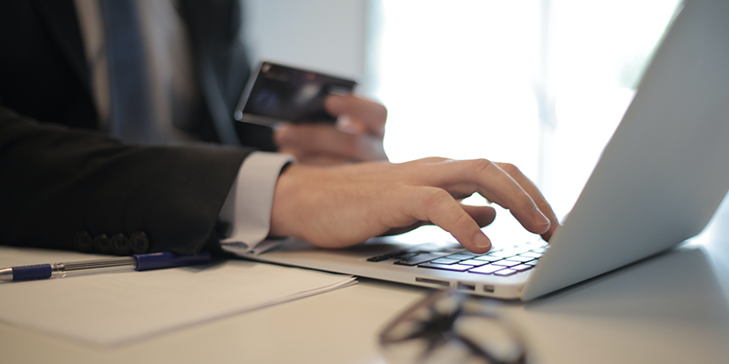 person-in-black-suit-typing-on-a-computer-3760081.jpg